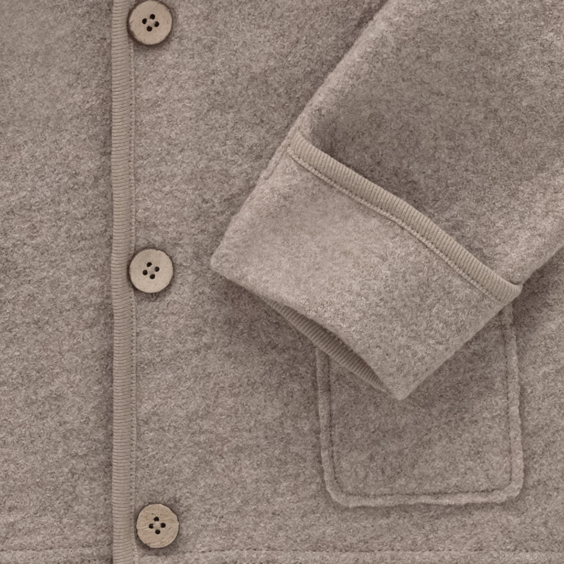 Wollen babyvest met omgeslagen boorden